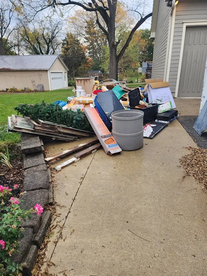 Dumpster being loaded with debris for Estate Cleanout Dumpster Rental in Oakland